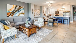 A modern living room with a sofa, coffee table, and decorative items. - Walk to Tucson Trails! Private Yard w/ Views (Tucson)