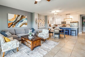 A modern living room with a sofa, coffee table, and decorative items. - Walk to Tucson Trails! Private Yard w/ Views (Tucson)