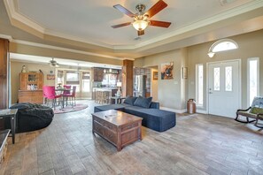 A spacious living room with a large sectional sofa, a wooden coffee table, and a ceiling fan. - Swim, Grill & Relax! Copperas Cove Family Home (Copperas Cove)