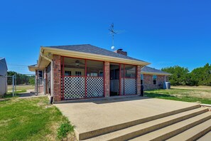 A single-story house with a porch, a chimney, and a satellite dish. - Swim, Grill & Relax! Copperas Cove Family Home (Copperas Cove)