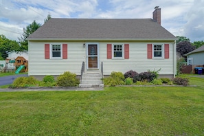 A single-story house with a front porch, a small front yard, and a visible satellite dish. - Fall Fun in the Berkshires: Yard, Patio, Playset (Pittsfield)