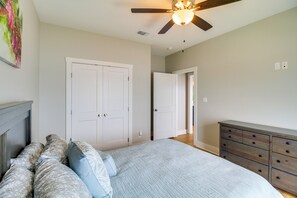 A bedroom with a bed, a dresser, and a ceiling fan. - Waterfront Home w/ Deck & Views on Copano Bay! (Taft)