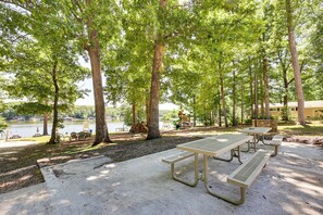 A park with picnic tables, a playground, and a lake view. - It's Our Pleasure! Lake Escape w/ Boat Ramp (Macon)