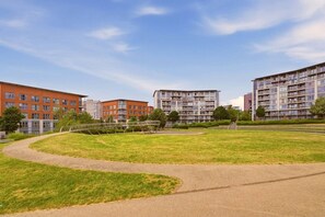 A residential complex with multiple apartment buildings, a central grassy area, and a pedestrian pathway. - #191 Mason Way Executive Stay - Sleeps 6 (West Midlands)