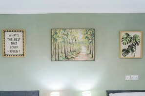 A room with a bed, a wall-mounted painting of a forest path, and a framed inspirational quote. - #134 Cozy Retreat Close to FarGo Village -Sleeps 7 (West Midlands)