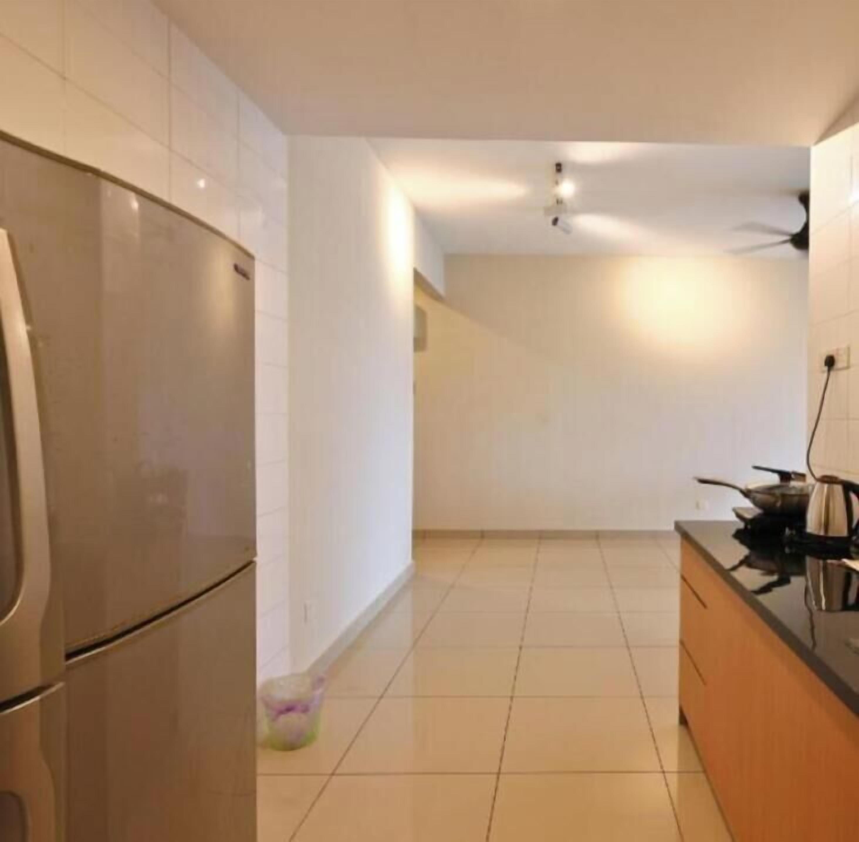A kitchen with a refrigerator, stove, and cabinets.