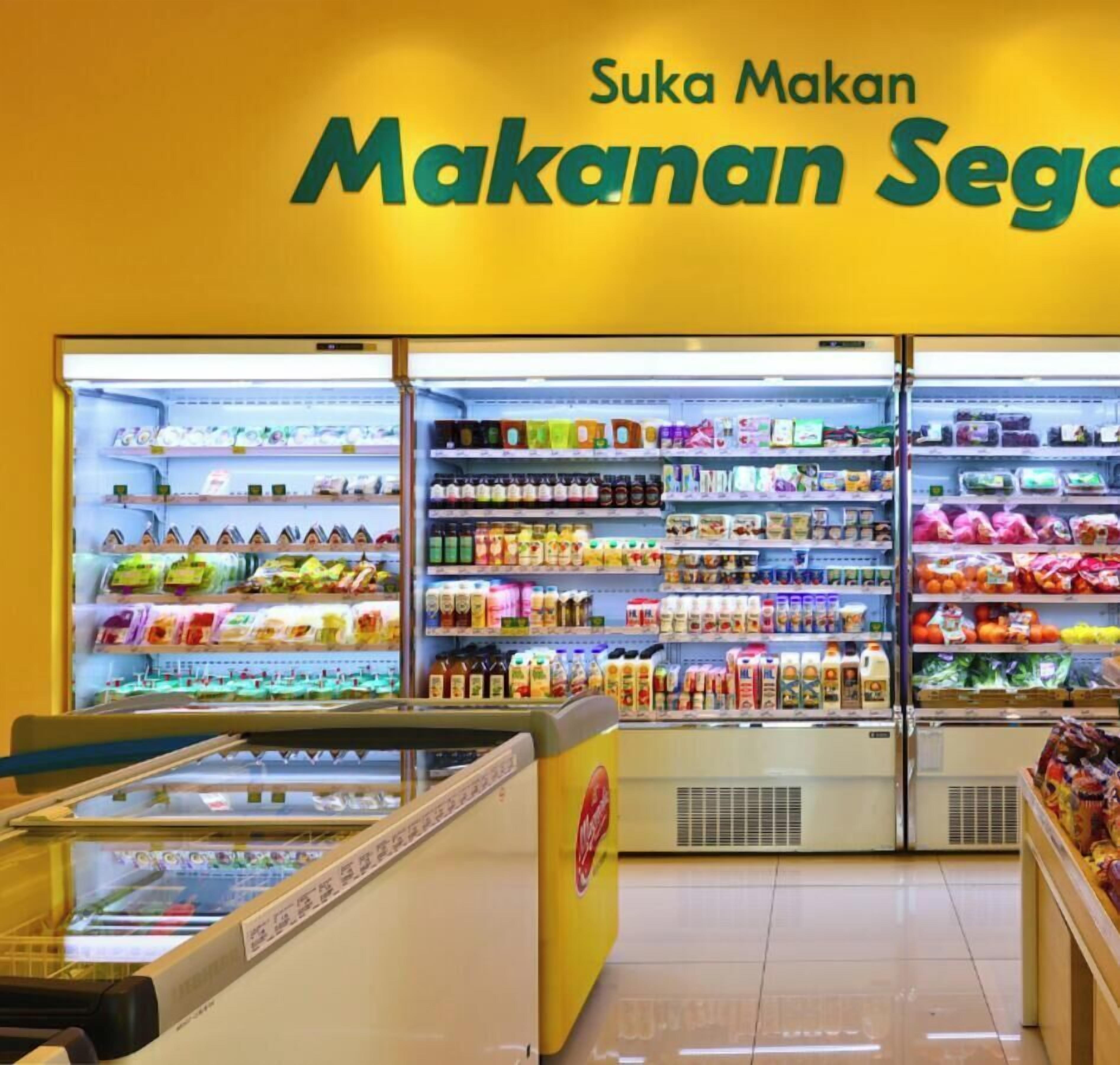 A grocery store with refrigerated sections and shelves stocked with various products.