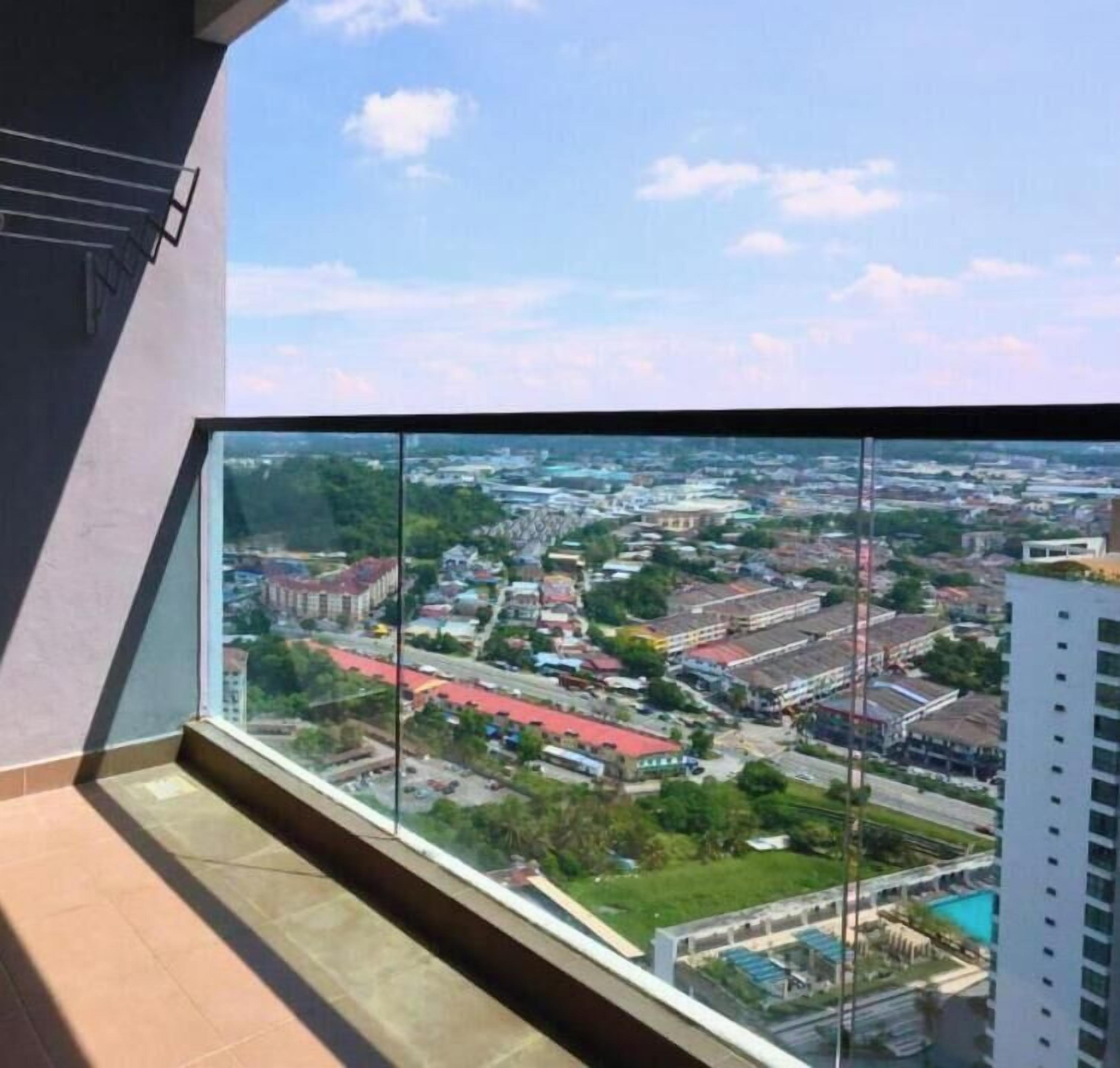 A balcony with a city view, a tiled floor, and a metal railing.
