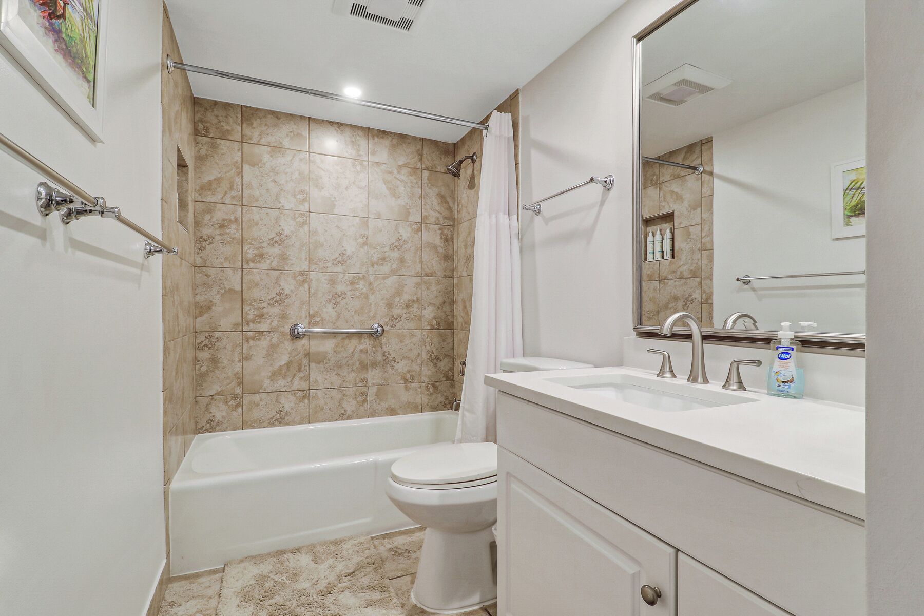 A bathroom with a bathtub, toilet, and sink.