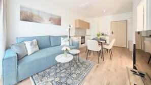 Ein modernes Wohnzimmer mit einer Couch, einem Esstisch und Stühlen.