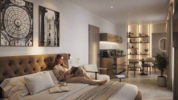 Ein modernes Schlafzimmer mit einem großen Bett, einer Leseecke, einer Küchenzeile und einem Essbereich.