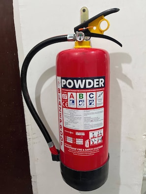 A red fire extinguisher mounted on a wall.