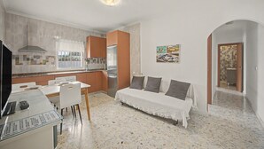 A compact living space with a kitchenette, dining area, and a sofa. - Holiday Home 'La Alberca' with Private Pool and Private Terrace (Vejer de la Frontera)