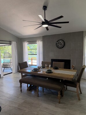A dining area with a table set for four, a ceiling fan, and a view of the outdoors. - 3-bedroom house in beautiful Sarasota with cool AC breeze and heated pool. (Sarasota)