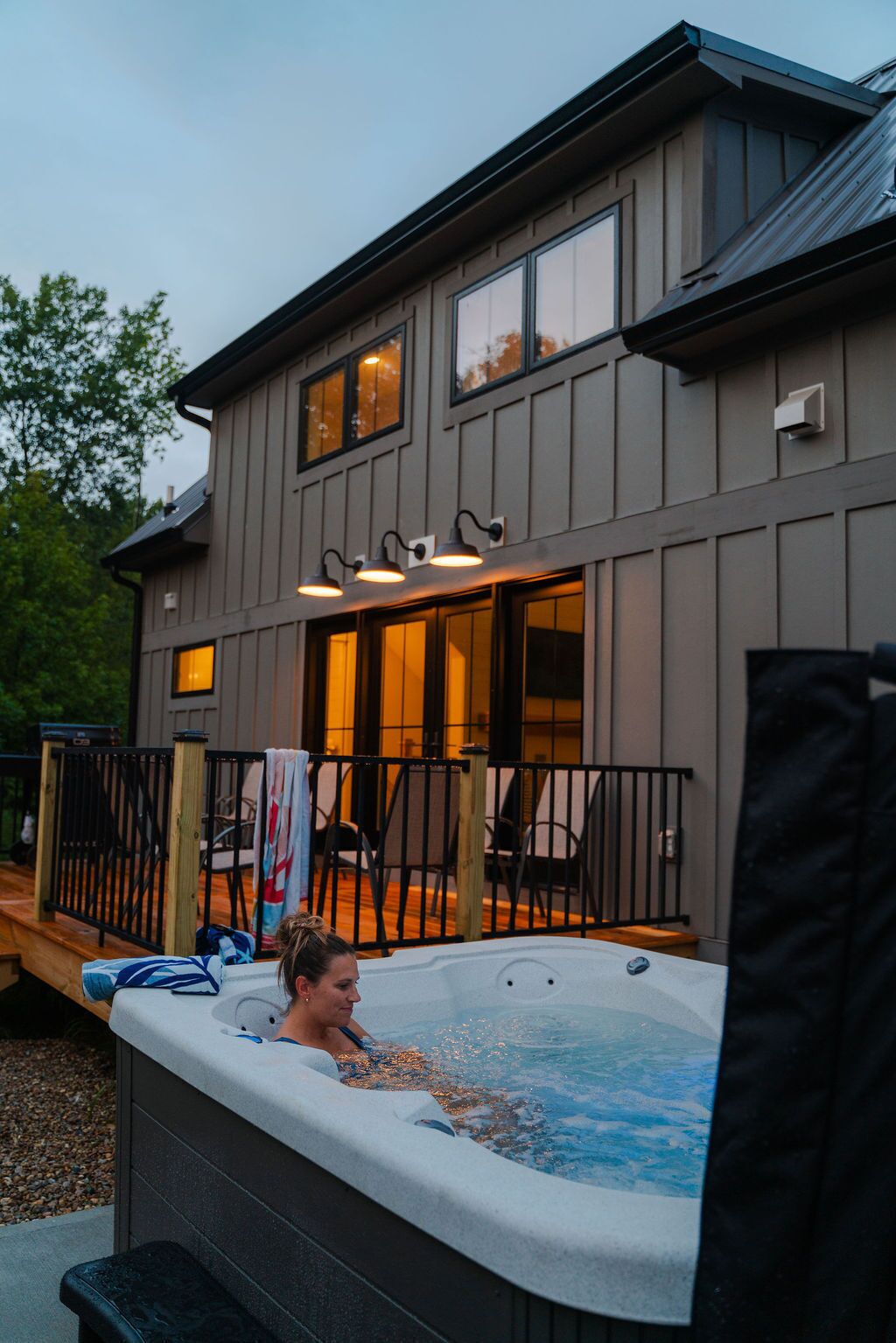 A two-story building with a hot tub in front.