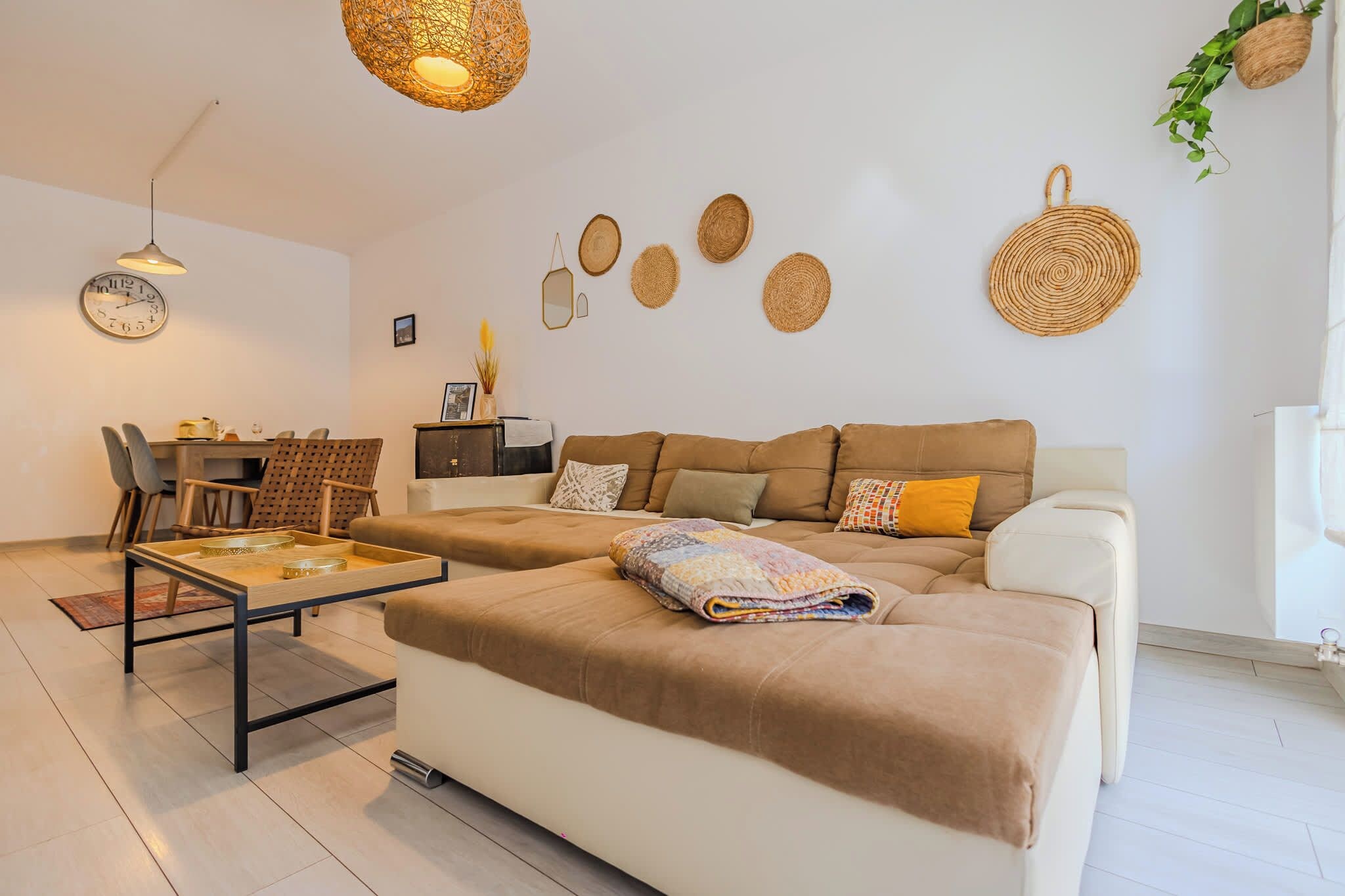 A modern living room with a sofa, coffee table, and decorative wall art.