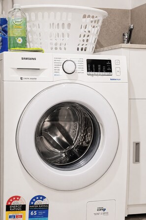 A Samsung digital inverter washing machine with a transparent door, a control panel with various wash settings, and a water rating label. - Hawthorn 2b charming retreat (Hawthorn)