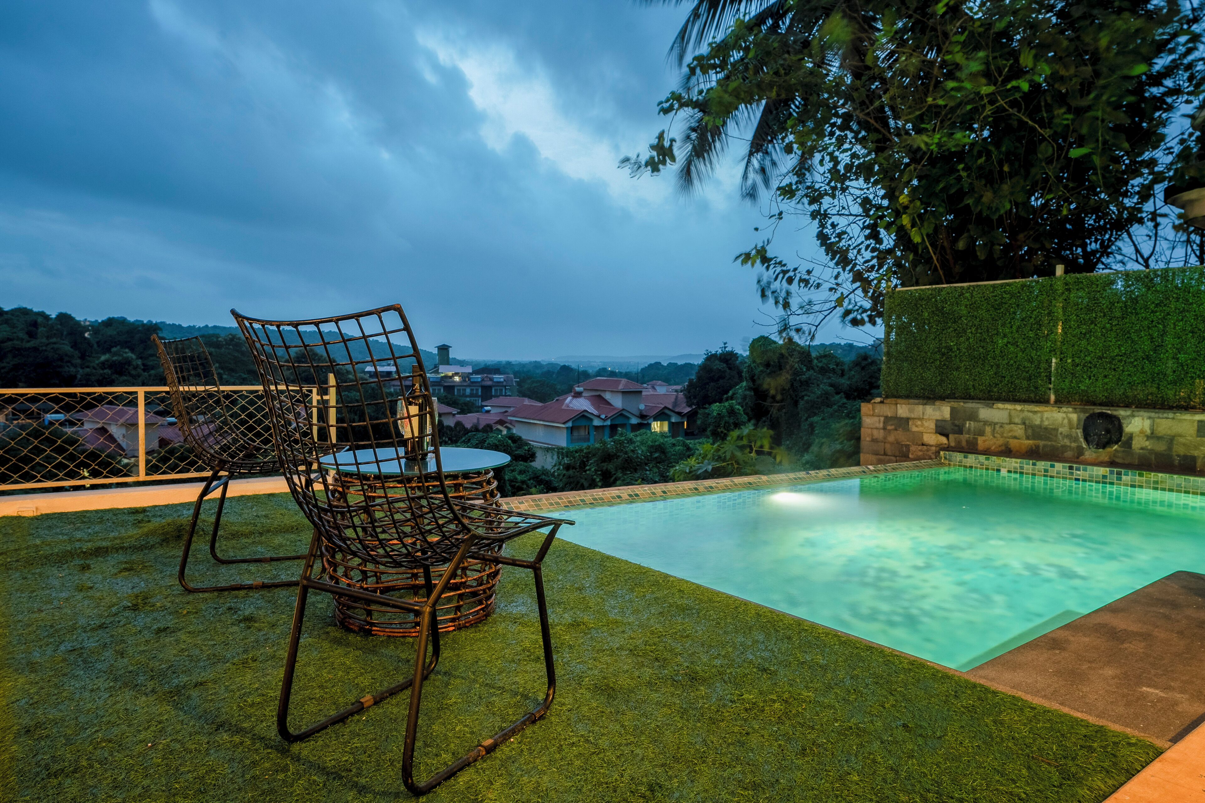 An outdoor swimming pool with a view of houses in the background.