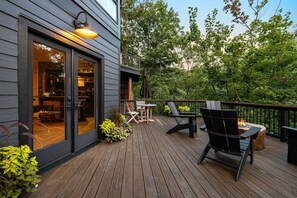 Eine Holzterrasse mit Sitzgelegenheiten und einem Feuerkorb.
