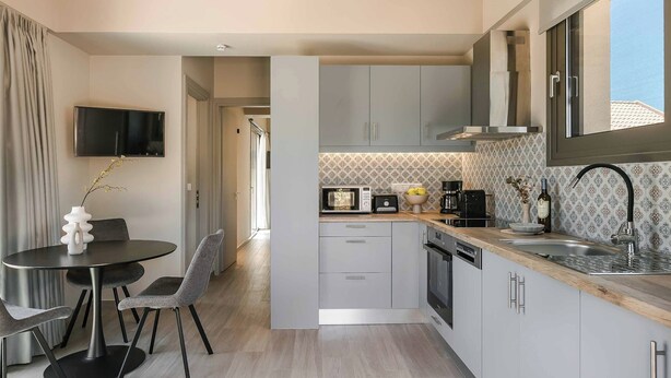 A modern kitchen with grey cabinets, a built-in microwave, and a coffee maker. - Sea Melody - Two Bedroom Villa, Sleeps 4 (Ionian Islands)