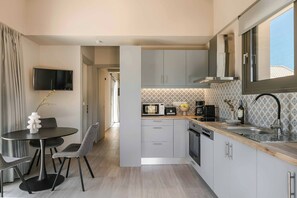 A modern kitchen with grey cabinets, a built-in microwave, and a coffee maker. - Sea Melody - Two Bedroom Villa, Sleeps 4 (Ionian Islands)