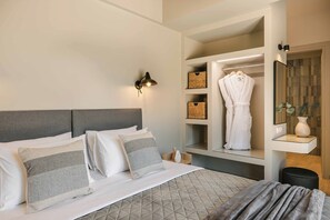 A hotel room with a bed, bedside tables, a mirror, and a wardrobe with built-in shelves. - Sea Melody - Two Bedroom Villa, Sleeps 4 (Ionian Islands)
