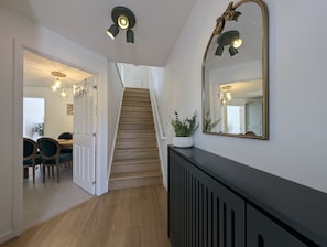 A staircase leading to a dining area with a table and chairs. - 3-Bed Home | Sleeps 5 | Free Parking | Newcastle - Pass the Keys (Newcastle)