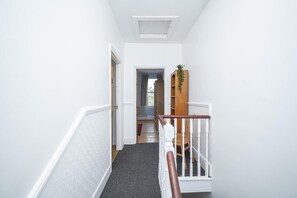 A narrow hallway with a staircase leading to a landing. - Camberwell house - with Central London bus links - Pass the Keys (London)