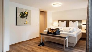 Ein Hotelzimmer mit Bett, Nachttisch und einem Bild an der Wand.