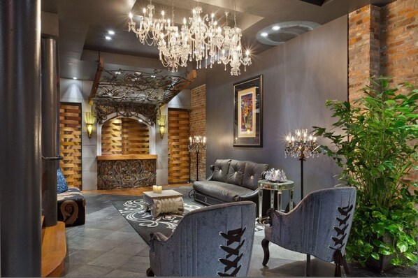 A modern interior with a chandelier, seating area, and a fireplace.