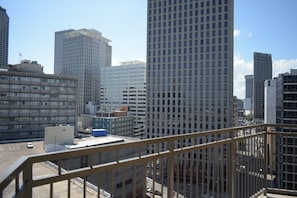 A cityscape with high-rise buildings, a clear sky, and a parking lot. - New Orleans | Couples NOLA Retreat | Pool + Fitness (New Orleans)
