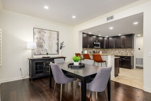 A modern kitchen with dark cabinets, a microwave, and a tiled backsplash. - Highly desired Desert Ridge condo on 1st level- no stairs, large patio (Phoenix)