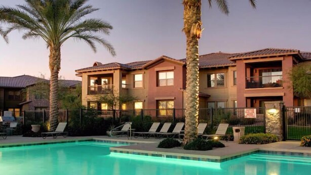 A pool area with lounge chairs and a two-story building with balconies. - Highly desired Desert Ridge condo on 1st level- no stairs, large patio (Phoenix)