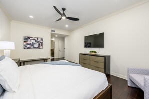 A bedroom with a bed, a desk, a chair, a dresser, a television, and a ceiling fan. - Highly desired Desert Ridge condo on 1st level- no stairs, large patio (Phoenix)
