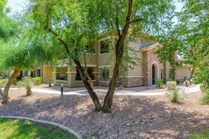 A multi-story building with a courtyard surrounded by trees and landscaping. - Highly desired Desert Ridge condo on 1st level- no stairs, large patio (Phoenix)