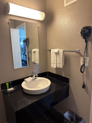 Habitación individual Deluxe, para no fumadores | Baño | Regadera, amenidades de baño gratuitas, toallas, jabón