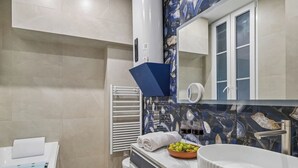 A modern bathroom with a white sink, a mirror, and a towel rack. - Lavie Maison - Spa Bath & AC, Heart of Saint-Merri (Paris)