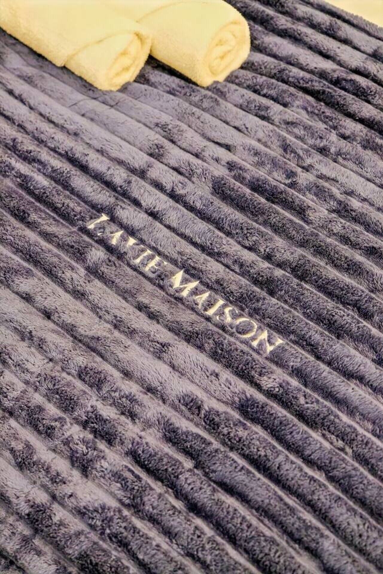 A textured fabric with the inscription 'LAUREN MAISON' on it.