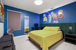 A bedroom with a bed, a desk, a chair, a mirror, and a wall with cartoon characters. - 7 Bd / 6,5 Ba / Sleeps 18 / Solara Resort (Kissimmee)