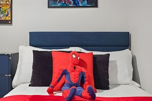 A bed with a headboard, a pillow with a Spiderman design, and a red blanket. - 3 Bd / 3 Ba / Sleeps 8 / The hub (Kissimmee)