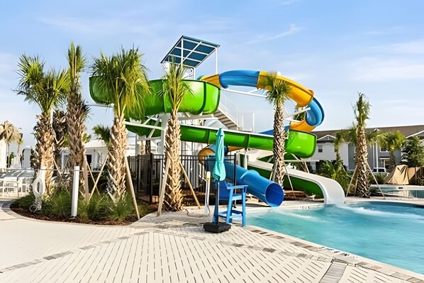 A water park with a multi-level water slide, a pool, and palm trees. - 8 Bd / 6 Ba / Sleeps 23 / Windsor Cay Resort (Clermont)