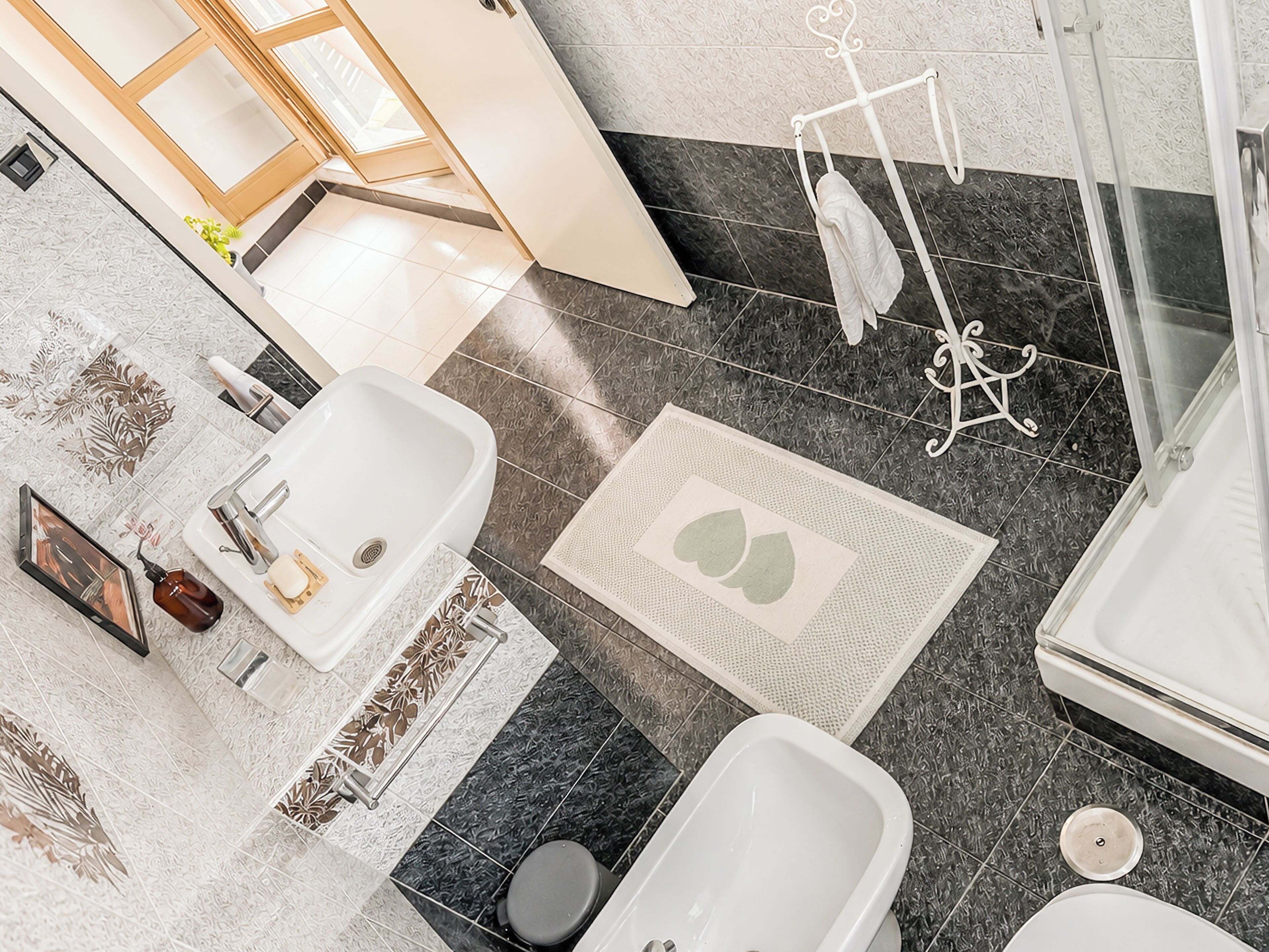 A modern bathroom with a bathtub, a sink, and a toilet.
