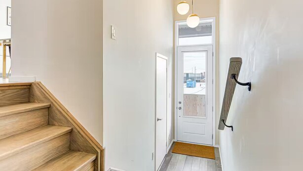 A staircase leading to a door with a view of the outside. - Family-Friendly Richmond Hill Home • Pet • Parking (Richmond Hill)