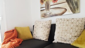 A black sofa with patterned cushions and a blanket. - Vacation Apartment 'En Mareverde Resort' with Sea View, Wi-Fi and Air Conditioning (Costa Adeje)