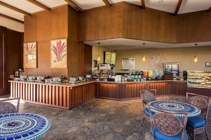 A buffet area with a counter, seating, and a stone-tiled floor.