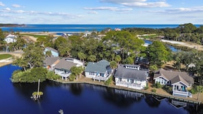 A residential area with houses surrounded by water, trees, and a clear view of the ocean. - Amazing Wildlife, Golf Cart Included - 15 Fairway Club (Fripp Island)