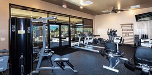 A gym with exercise equipment, large windows, and a view of the outdoors. - The Jewel near Sedona (Cornville)