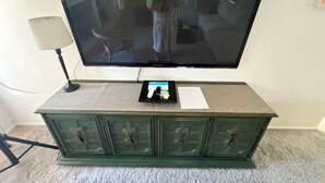 A television on a green cabinet with a remote control and papers on it. - The Jewel near Sedona (Cornville)