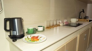 En köksbänk med en kaffebryggare, en tallrik mat och en diskho.