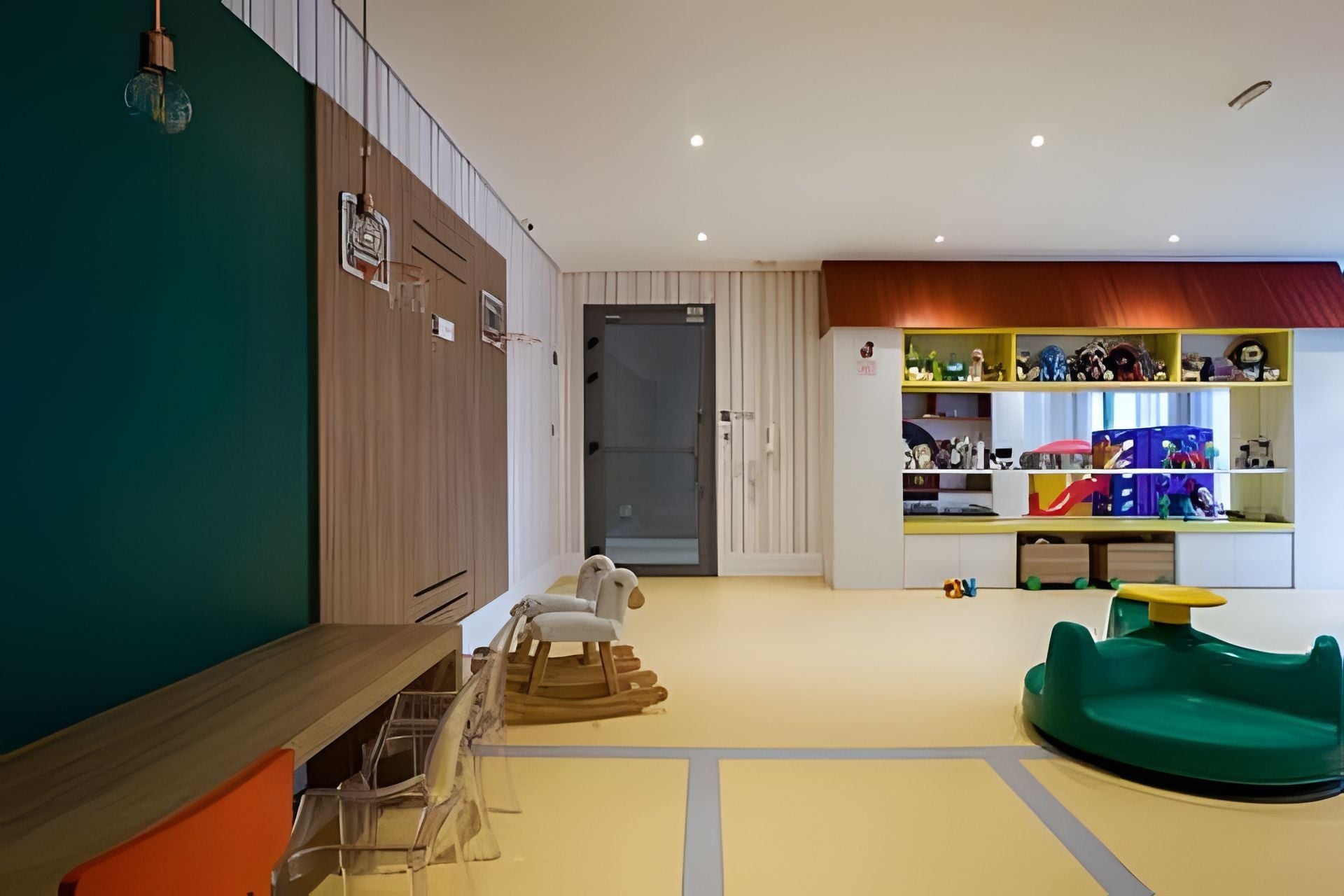 A children's play area with a slide, a play table, and a toy car.